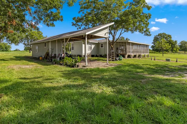 a view of a house with yard and a garden