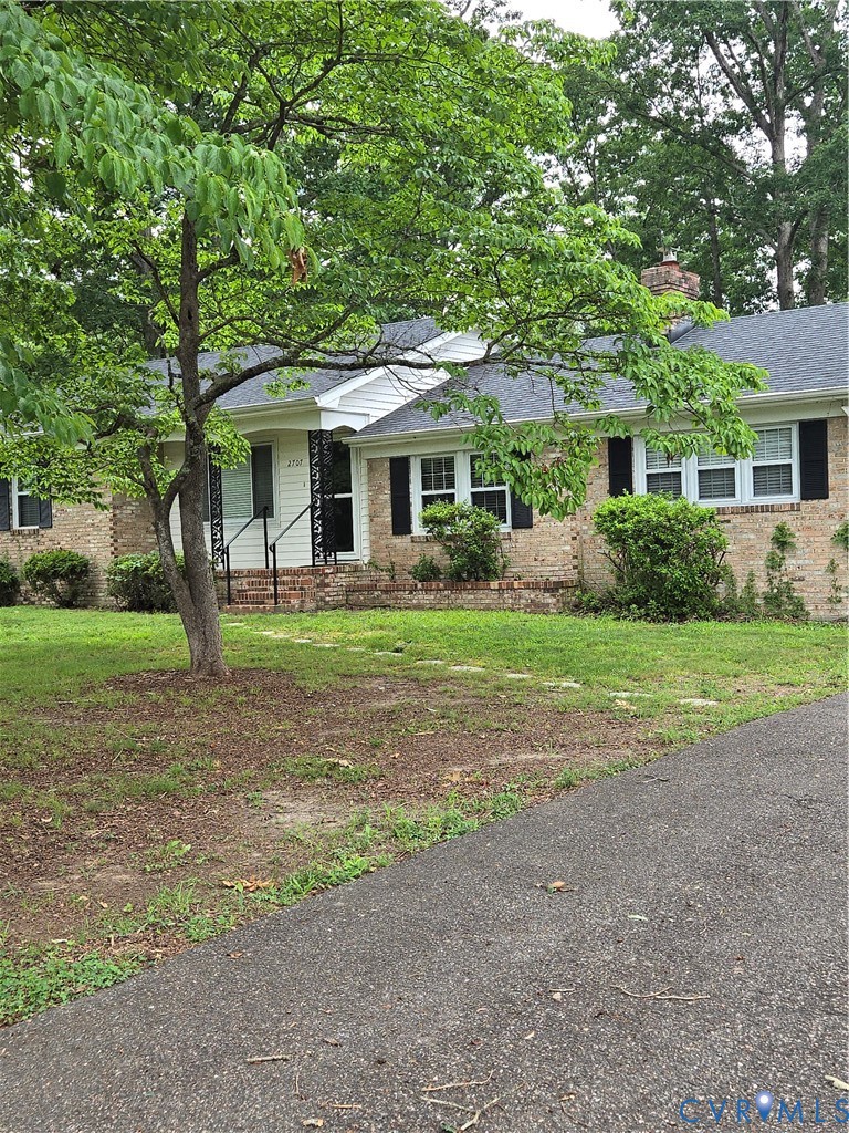 2707 Academy Road Powhatan, VA 23139 - Photo 2 of 27 a front view of a house with a garden