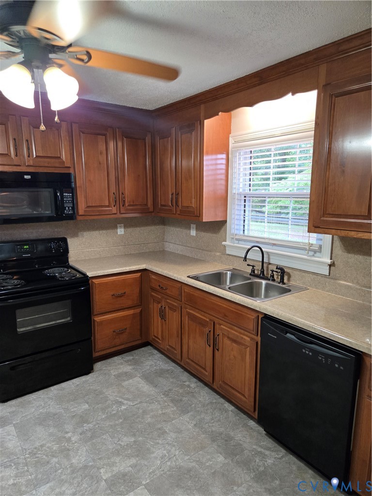 2707 Academy Road Powhatan, VA 23139 - Photo 6 of 27 a kitchen with stainless steel appliances granite countertop a sink a stove and a microwave