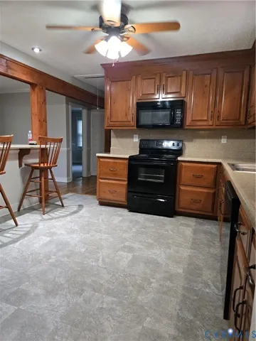 a kitchen with stainless steel appliances granite countertop a stove and a refrigerator