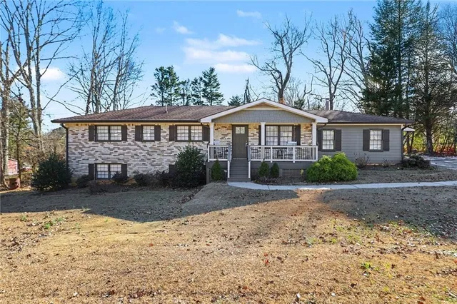 a front view of a house with a yard covered in snow