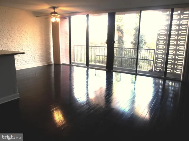 a view of an empty room and wooden floor