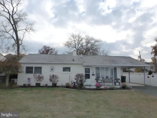 a front view of a house with a garden and plants