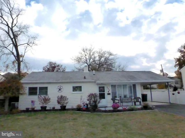 a front view of house with yard outdoor seating and barbeque oven