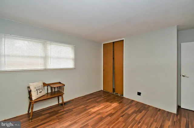 a view of a room with wooden floor and a window