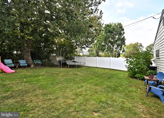 a view of a backyard with sitting area