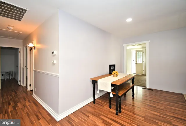 a view of a workspace with wooden floor