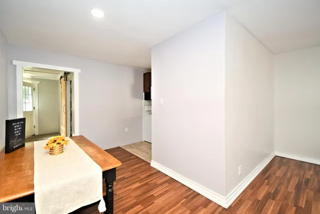 a view of a bedroom with wooden floor