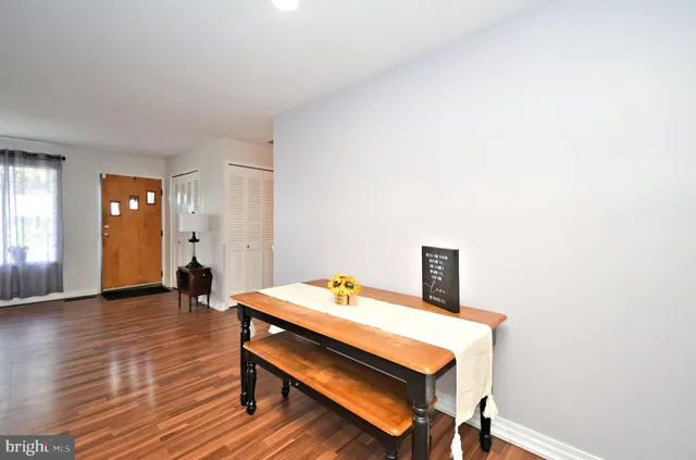 a reading room with wooden floor and furniture