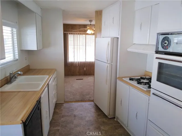 a kitchen with a stove a refrigerator and a sink