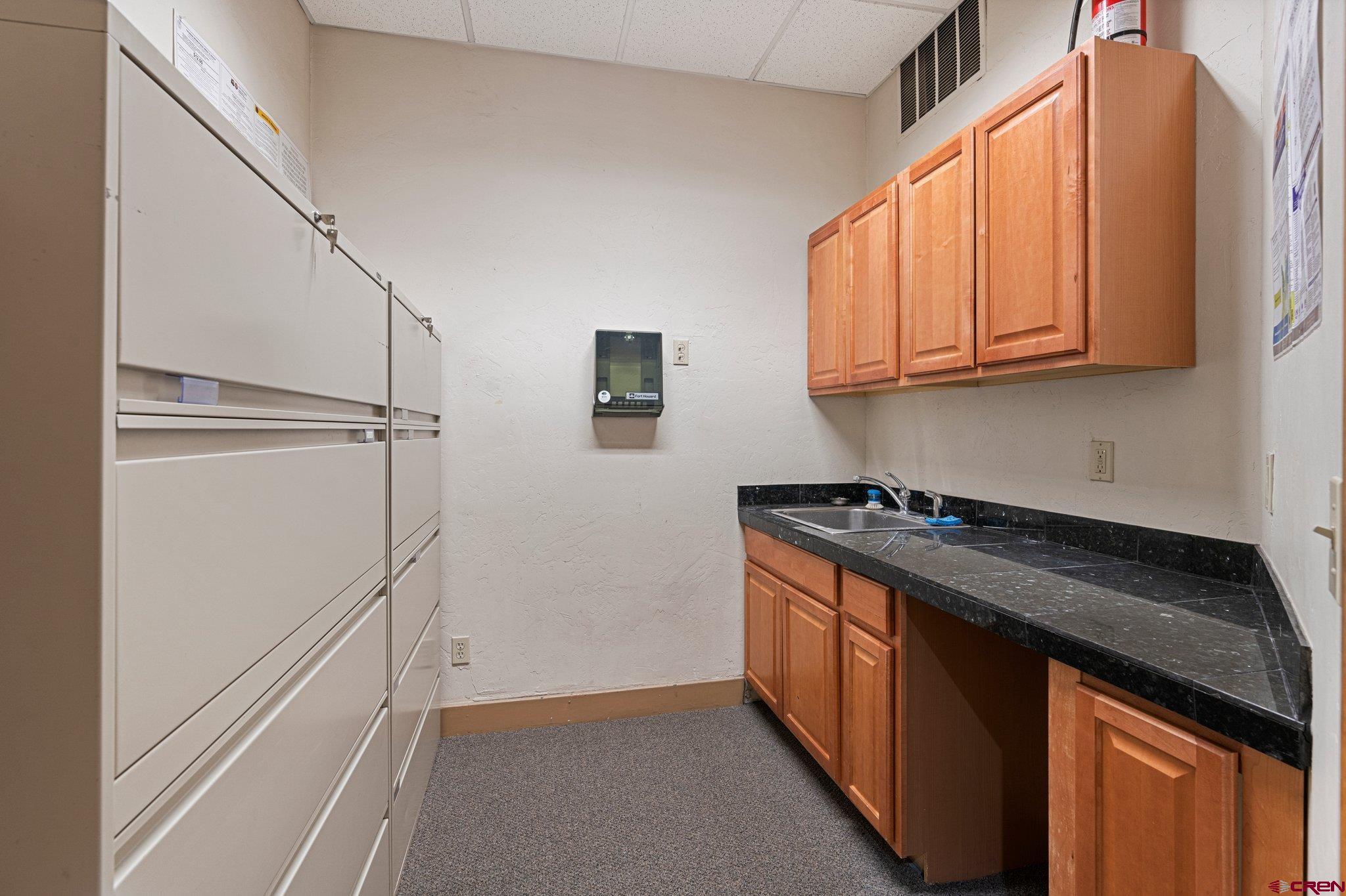 1150 Main Avenue Durango, CO 81301 - Photo 30 of 35 a kitchen with stainless steel appliances granite countertop a refrigerator and a stove top oven