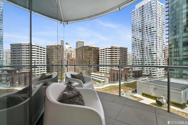 a bedroom with furniture and a large window