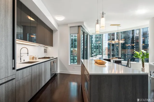 a kitchen with sink a refrigerator and cabinets