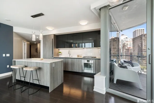 a large white kitchen with a large window