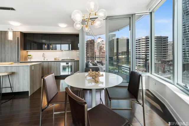 a dining room with furniture a chandelier and wooden floor