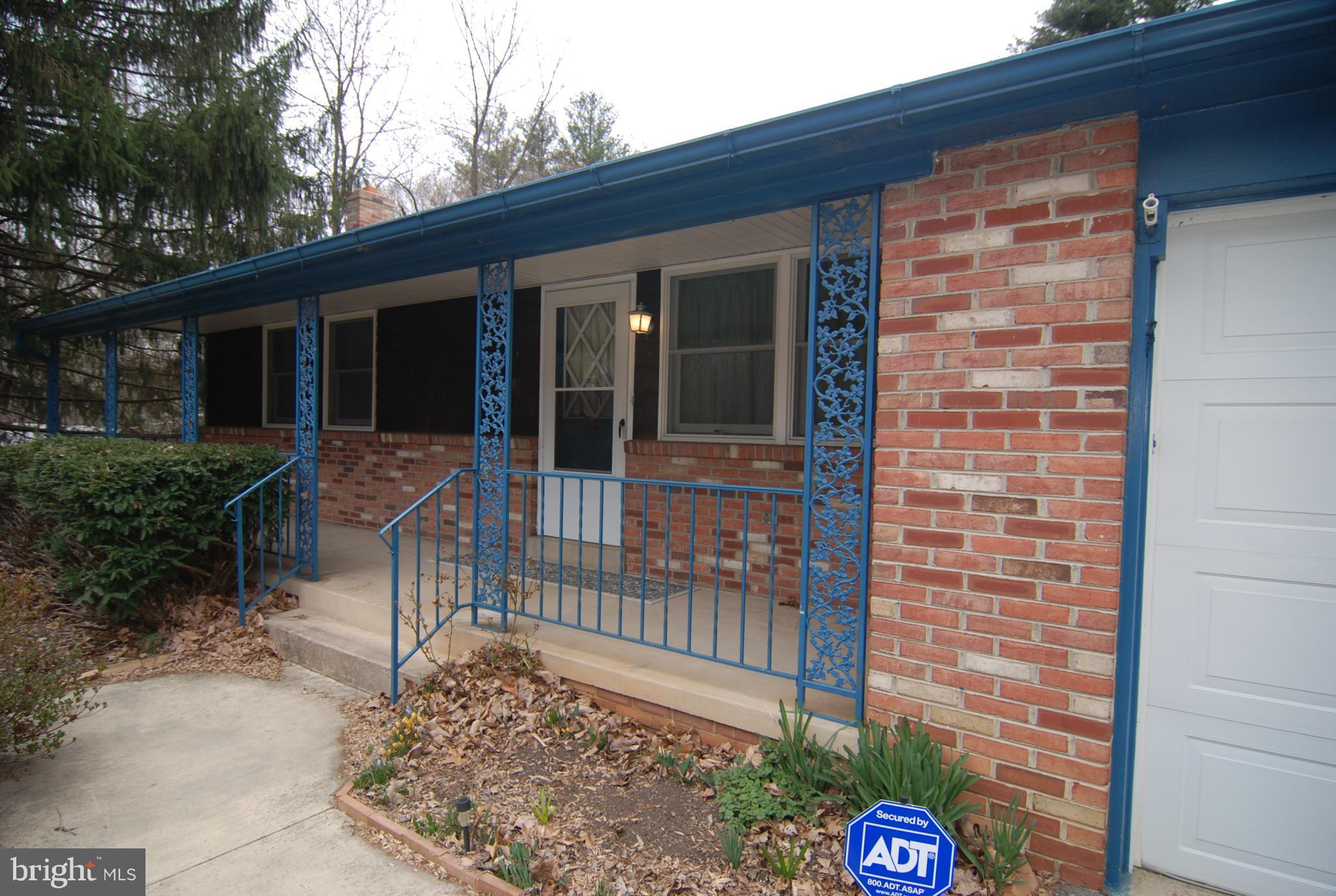 6712 South Clifton Road Frederick, MD 21703 - Photo 1 of 28 a front view of a house with a glass door