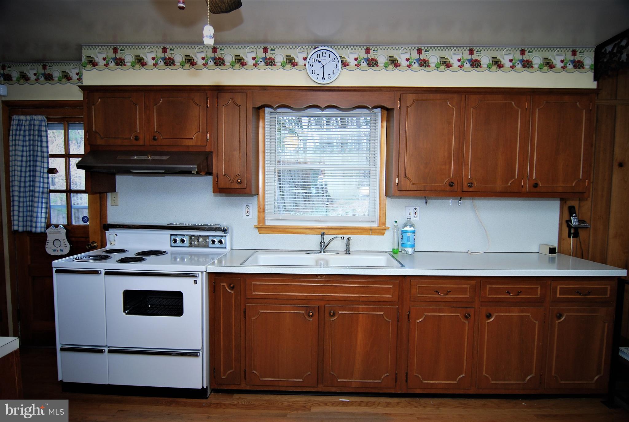 6712 South Clifton Road Frederick, MD 21703 - Photo 2 of 28 a kitchen with stainless steel appliances granite countertop a stove and a microwave