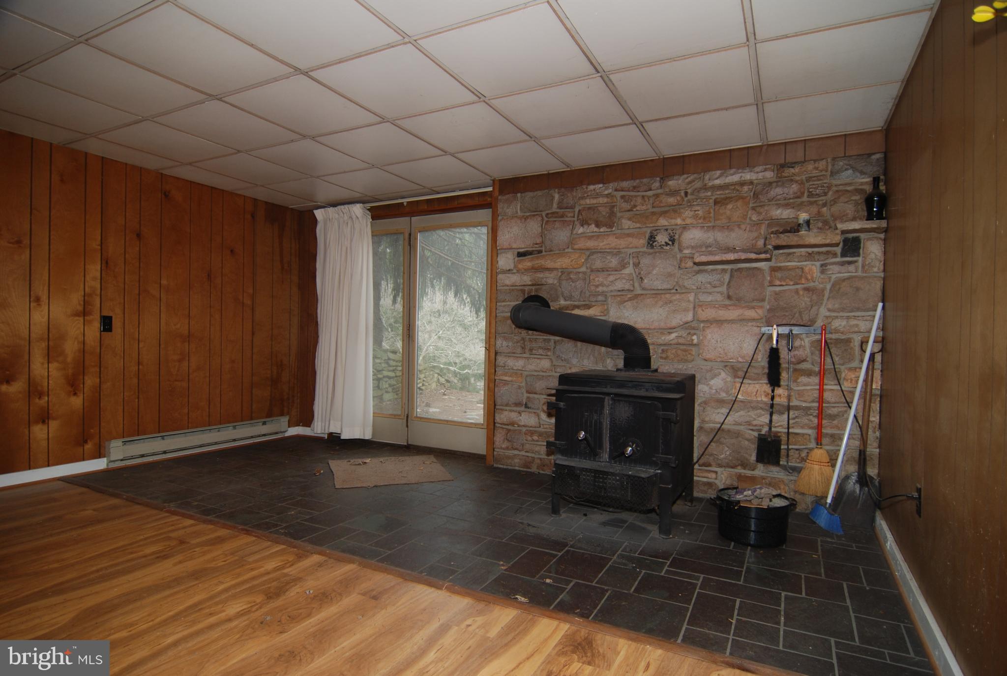 6712 South Clifton Road Frederick, MD 21703 - Photo 14 of 28 a view of an empty room with wooden floor and a fireplace