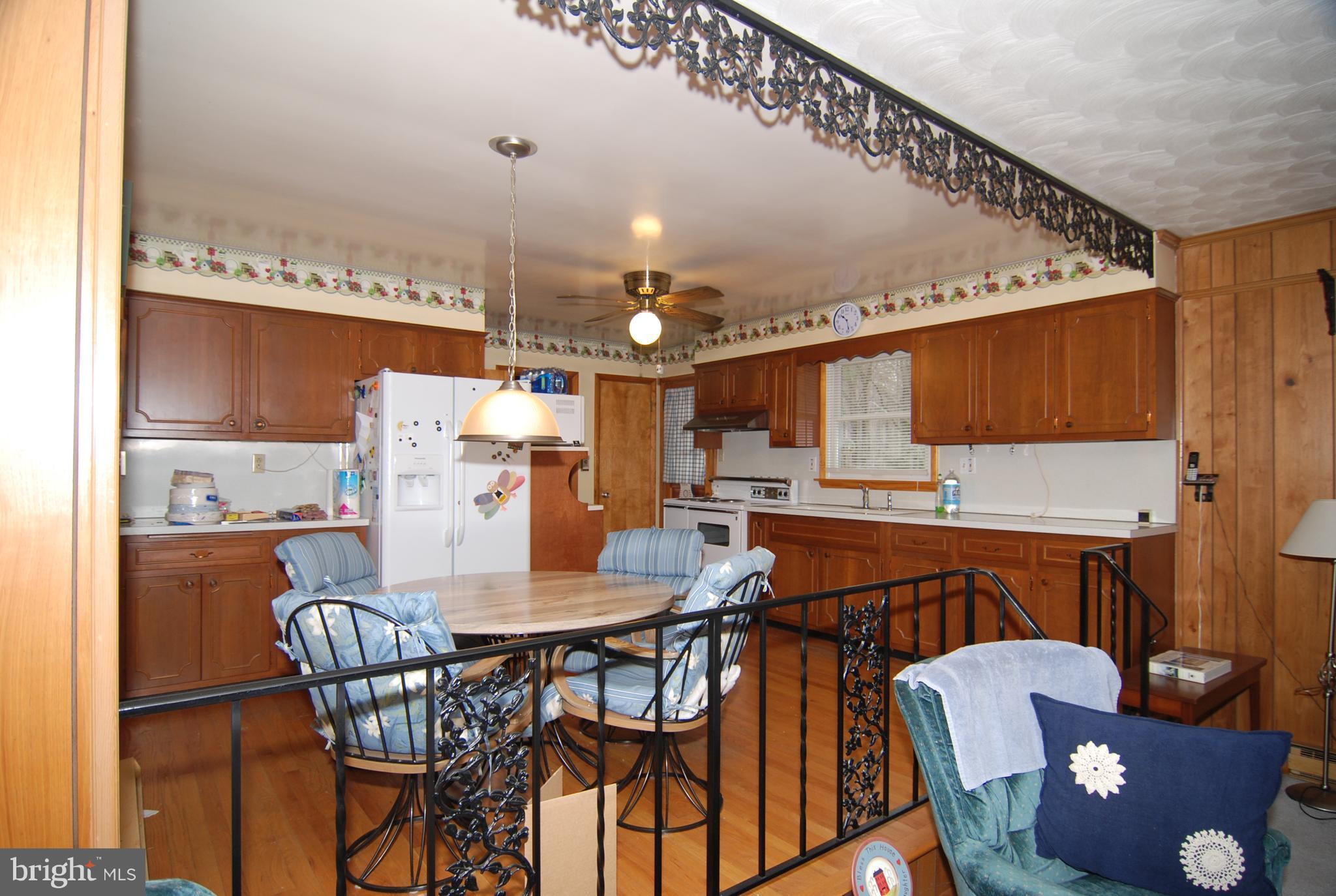 6712 South Clifton Road Frederick, MD 21703 - Photo 3 of 28 a dining room with furniture and wooden floor