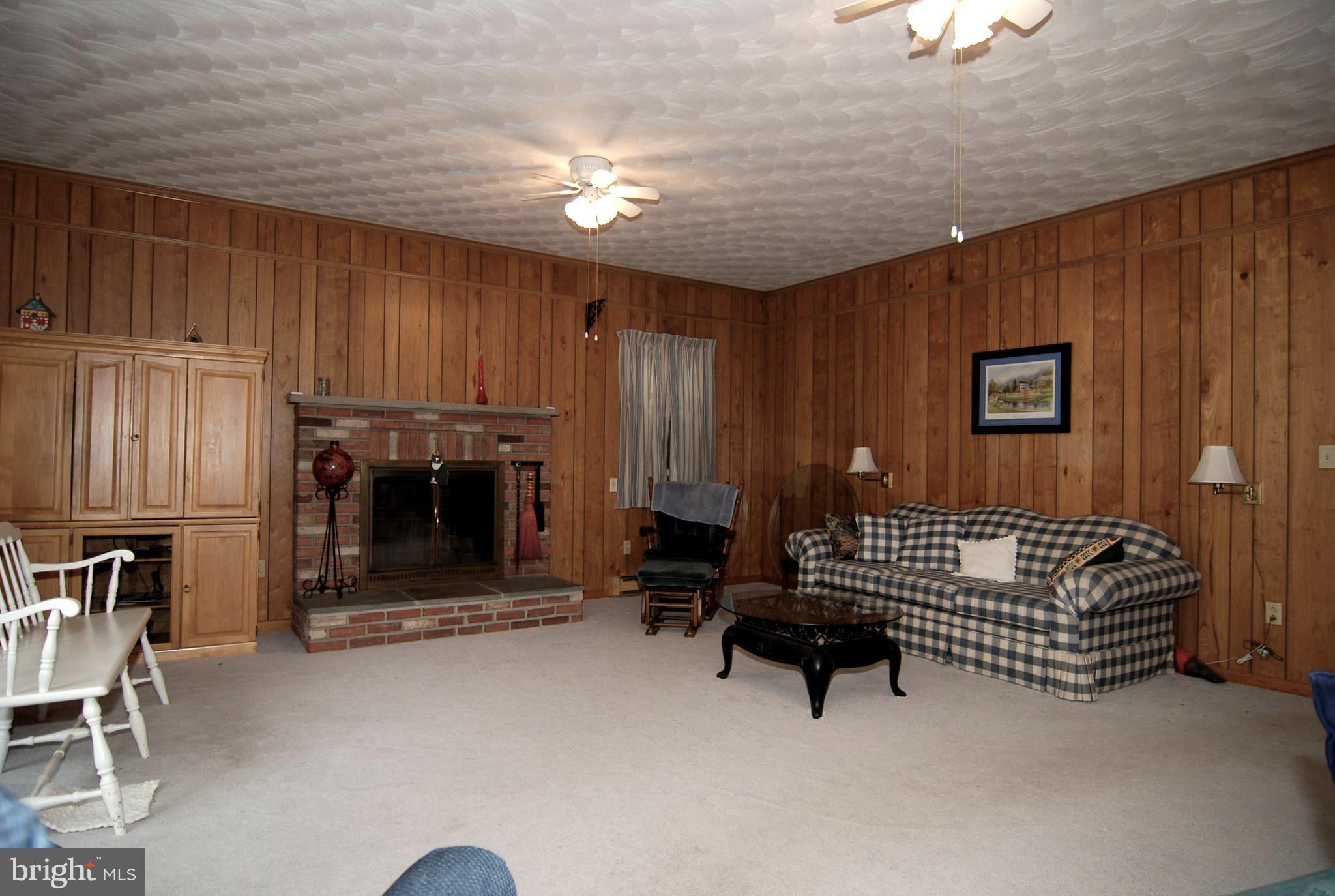 6712 South Clifton Road Frederick, MD 21703 - Photo 4 of 28 a living room with furniture and a fireplace