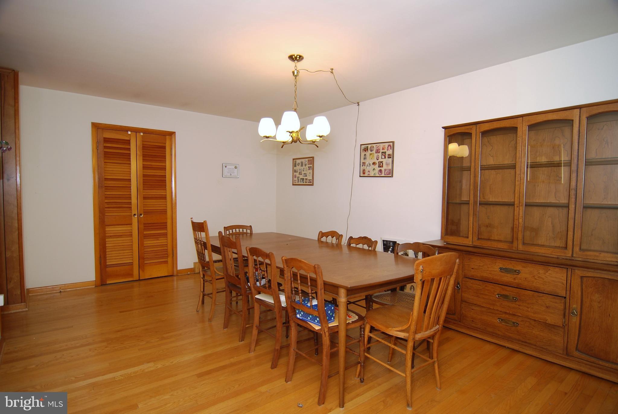 6712 South Clifton Road Frederick, MD 21703 - Photo 5 of 28 a view of a dining room with furniture and wooden floor