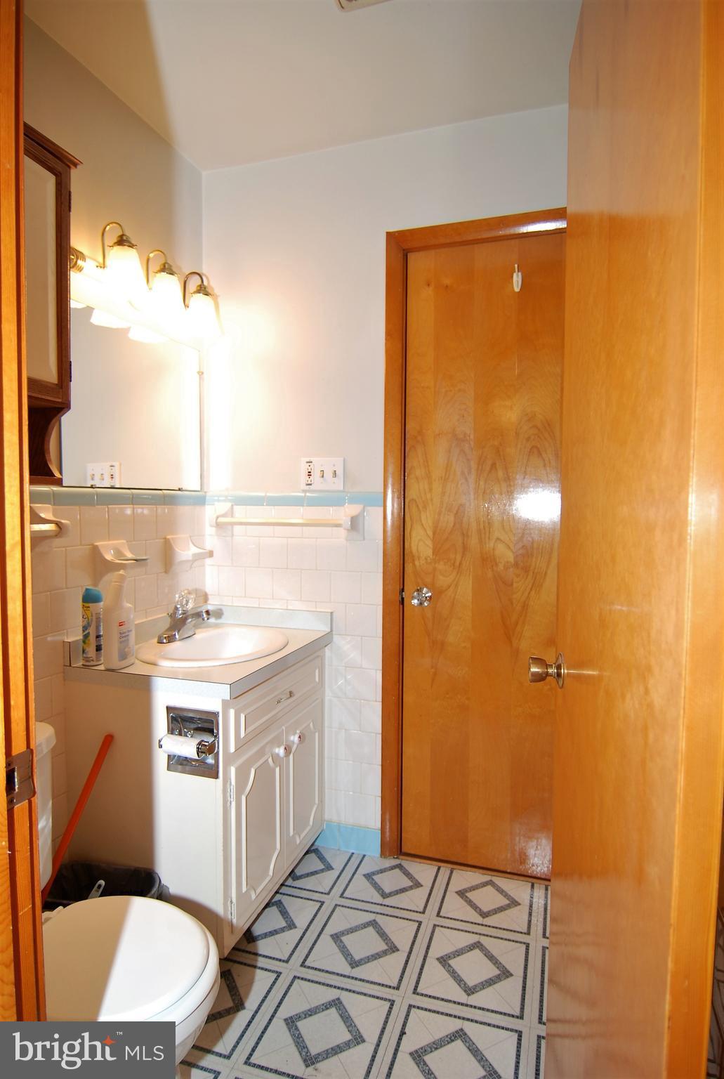 6712 South Clifton Road Frederick, MD 21703 - Photo 8 of 28 a bathroom with a granite countertop sink and a mirror