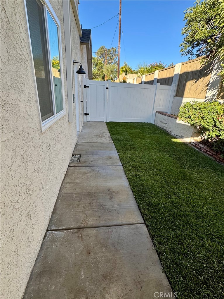6210 Halsted Avenue Rancho Cucamonga, CA 91737 - Photo 12 of 21 a view of a pathway with a house in the background