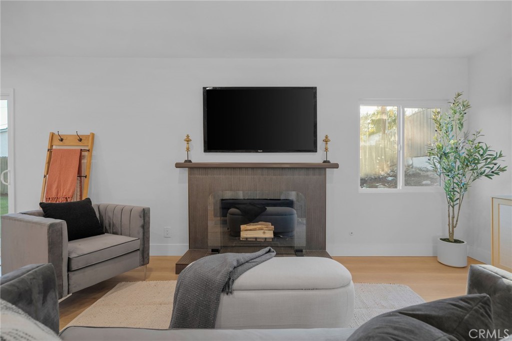 6210 Halsted Avenue Rancho Cucamonga, CA 91737 - Photo 3 of 21 a living room with furniture a potted plant and a fireplace