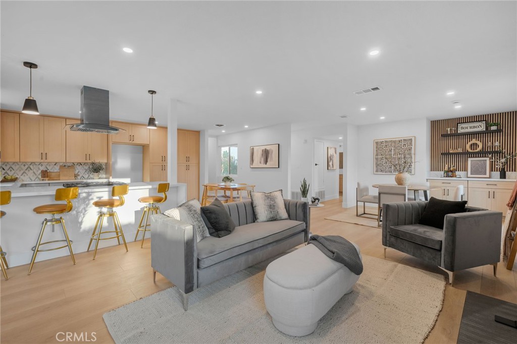 6210 Halsted Avenue Rancho Cucamonga, CA 91737 - Photo 4 of 21 a living room with lots of furniture and kitchen view