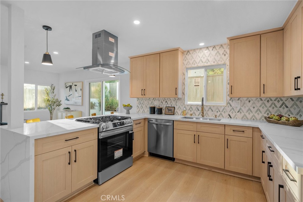 6210 Halsted Avenue Rancho Cucamonga, CA 91737 - Photo 6 of 21 a kitchen with a sink stove and cabinets