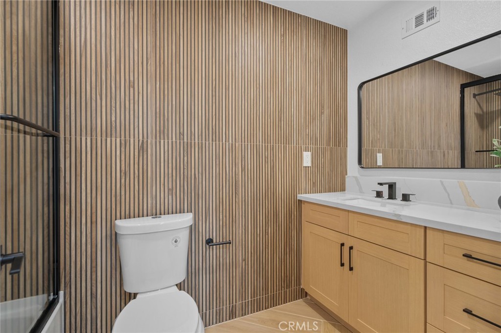 6210 Halsted Avenue Rancho Cucamonga, CA 91737 - Photo 8 of 21 a bathroom with a toilet a sink and mirror