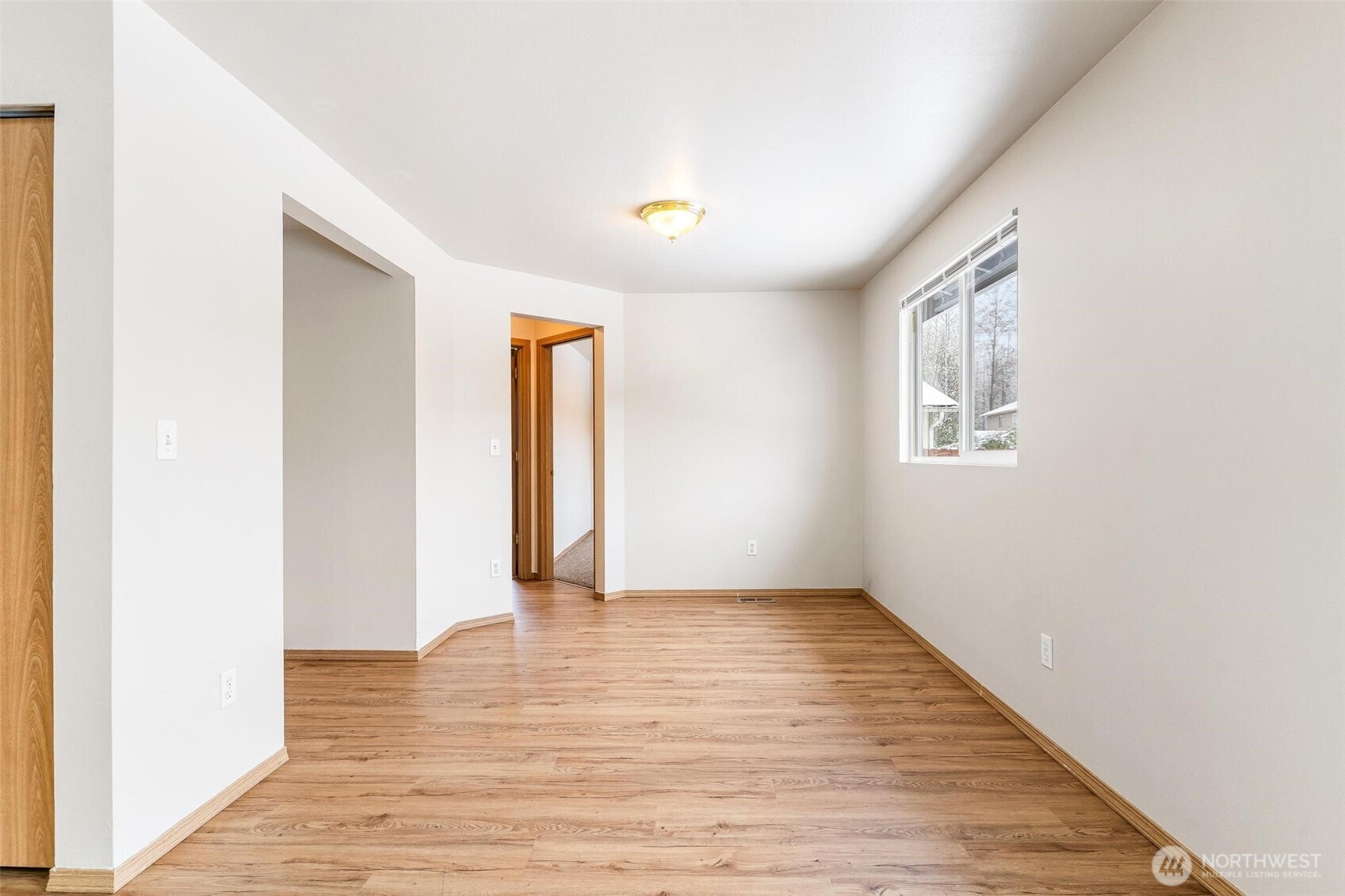 924 Merea Lane Sultan, WA 98294 - Photo 14 of 30 a view of an empty room with wooden floor and a window