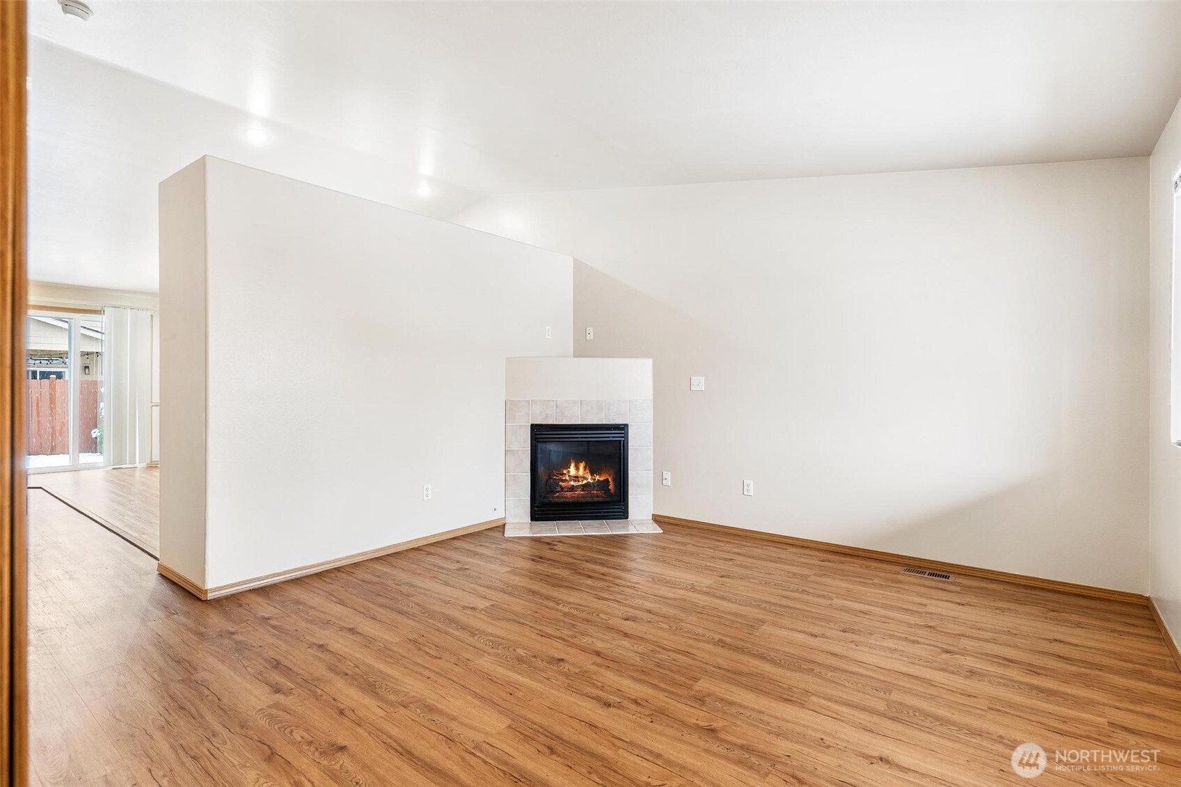 924 Merea Lane Sultan, WA 98294 - Photo 5 of 30 a view of an empty room with wooden floor fireplace and a window