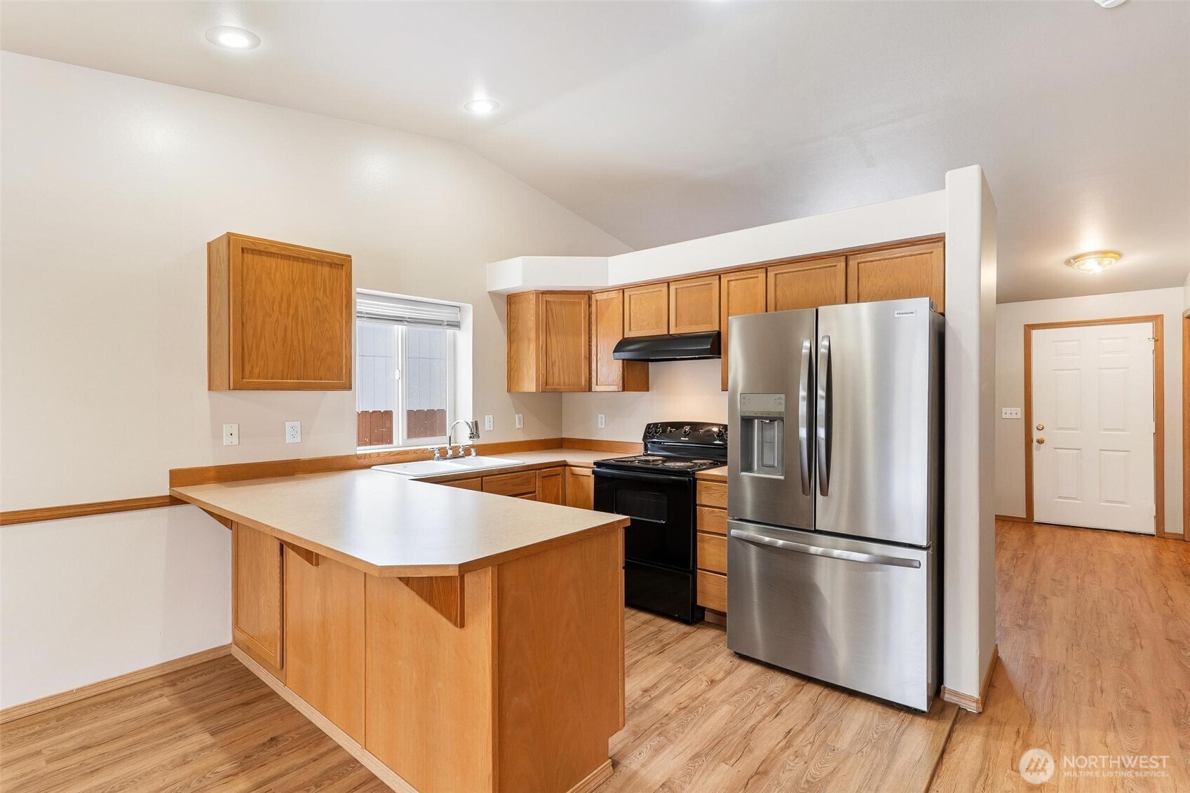 924 Merea Lane Sultan, WA 98294 - Photo 8 of 30 a kitchen with stainless steel appliances granite countertop a refrigerator a sink a stove a microwave and island