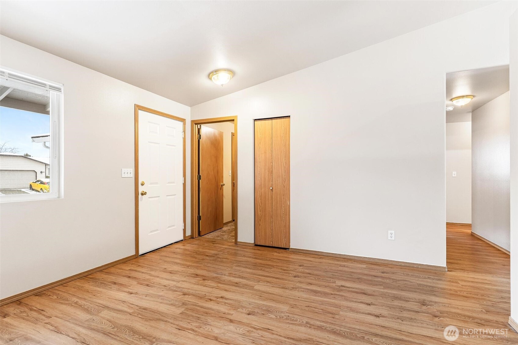 924 Merea Lane Sultan, WA 98294 - Photo 10 of 30 a view of an empty room with wooden floor and a window