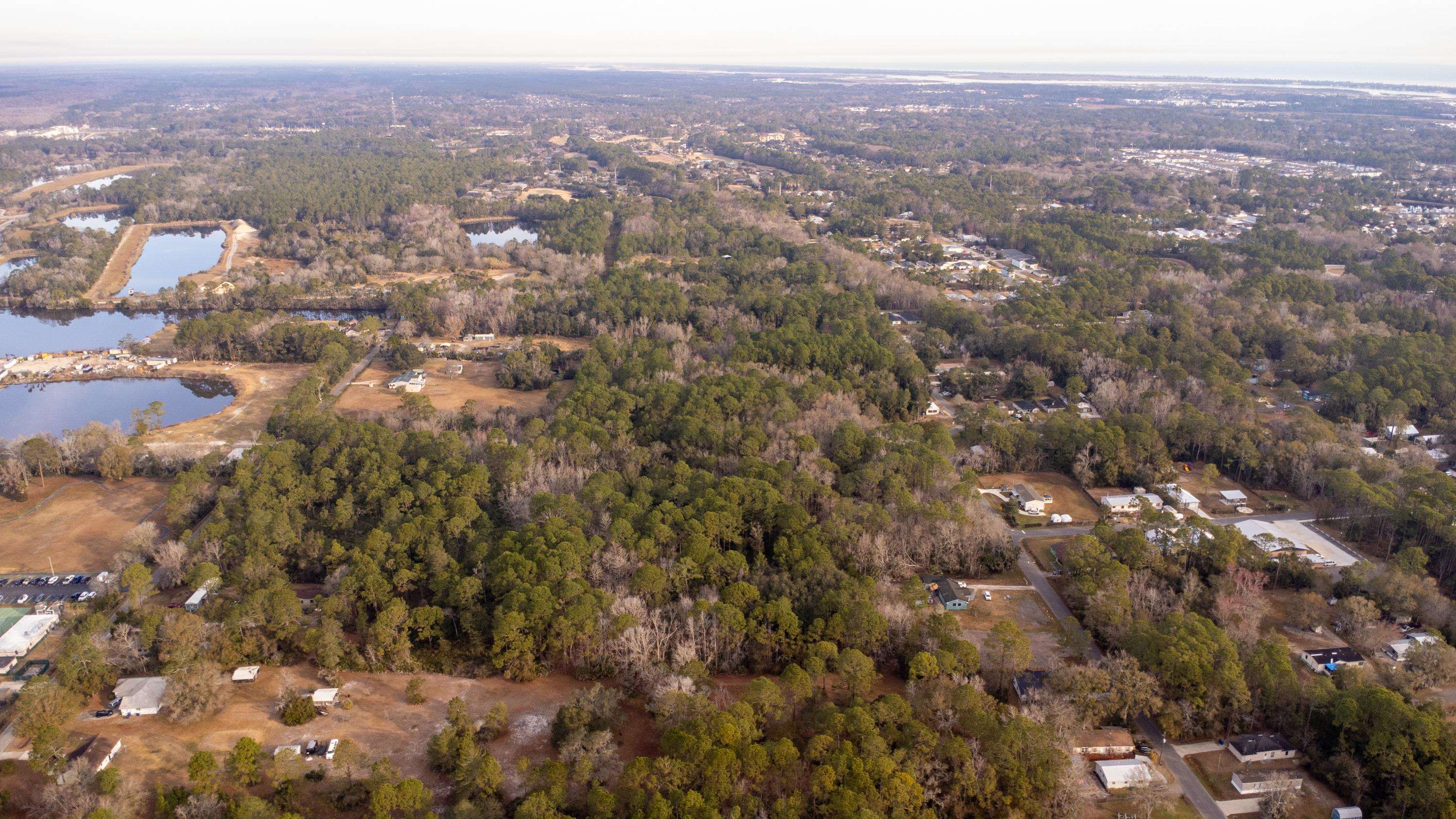 0 North Clay Street St. Augustine, FL 32084 - Photo 11 of 22 Aerial view of property's location featuring a nearby body of water and a heavily wooded area