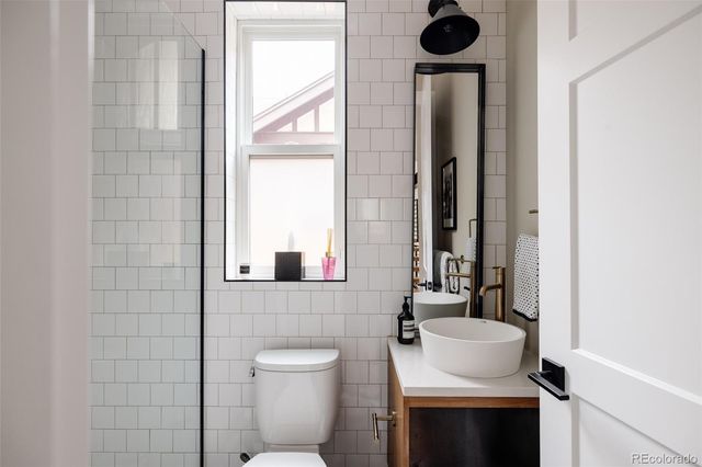 a bathroom with a toilet a sink and a mirror