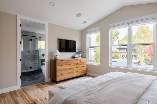 a bathroom with a tub mirror and sink