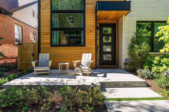 a view of house with backyard and outdoor seating