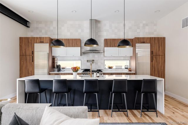 a kitchen with stainless steel appliances a sink and cabinets