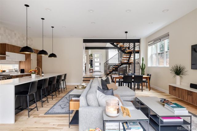 a dining room with furniture window and wooden floor