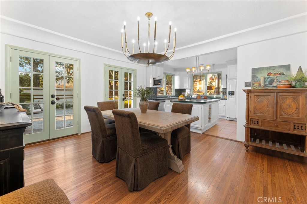 4855 Glenwood Drive Riverside, CA 92501 - Photo 12 of 39 a view of a dining room with furniture window and wooden floor