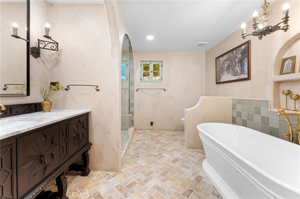 4855 Glenwood Drive Riverside, CA 92501 - Photo 13 of 39 a bathroom with a sink a toilet and shower