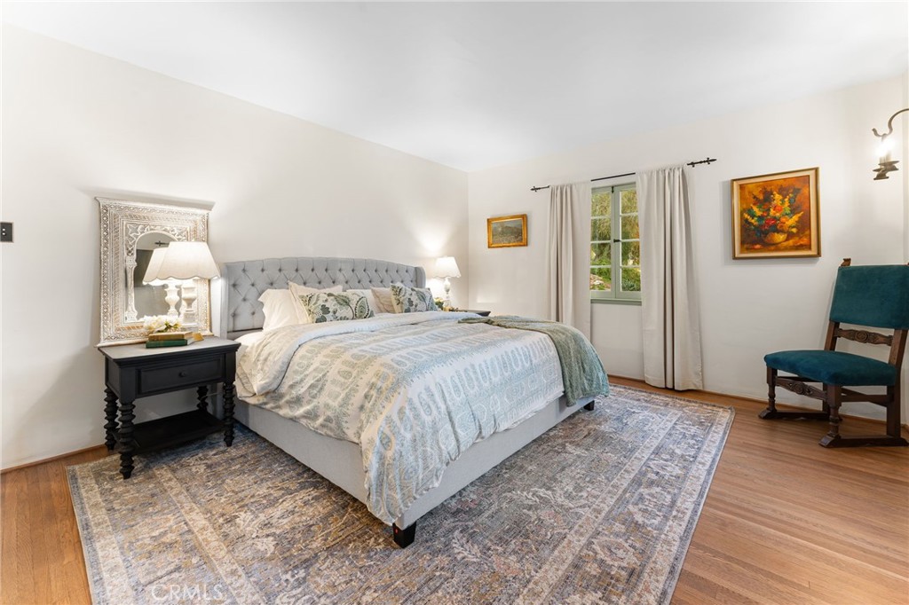 4855 Glenwood Drive Riverside, CA 92501 - Photo 16 of 39 a bedroom with a bed a table and chair