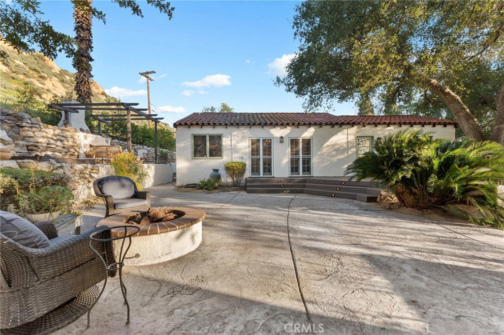 4855 Glenwood Drive Riverside, CA 92501 - Photo 29 of 39 a view of a patio with couches and a fire pit and wooden fence