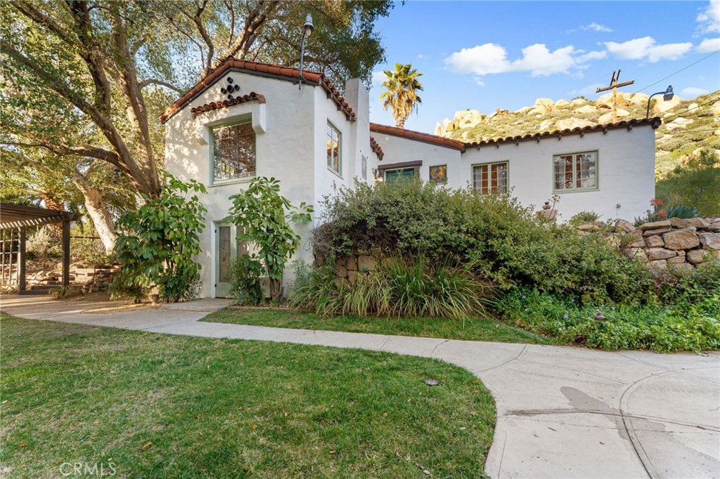 4855 Glenwood Drive Riverside, CA 92501 - Photo 7 of 39 a front view of a house with a yard and trees