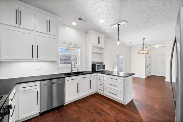 a kitchen with white cabinets sink and white appliances