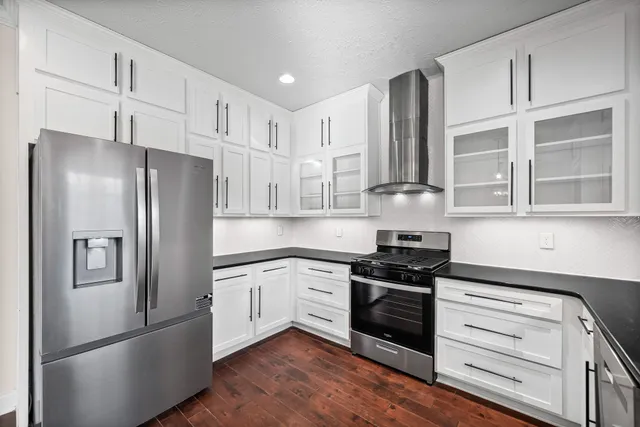 a kitchen with stainless steel appliances a refrigerator stove and sink