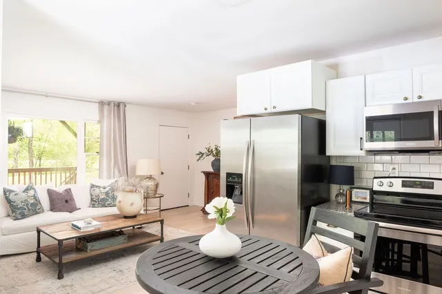 a kitchen with stainless steel appliances a refrigerator and a stove top oven