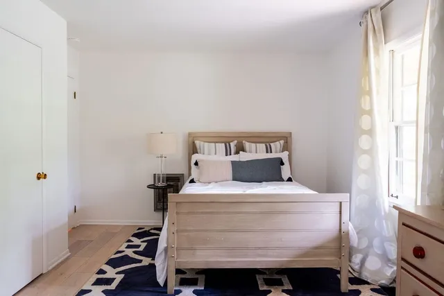 a bedroom with a bed and a window